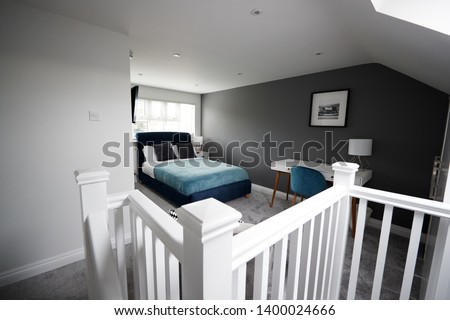 Interior of a house, loft conversion bedroom Royalty-Free Stock Photo #1400024666