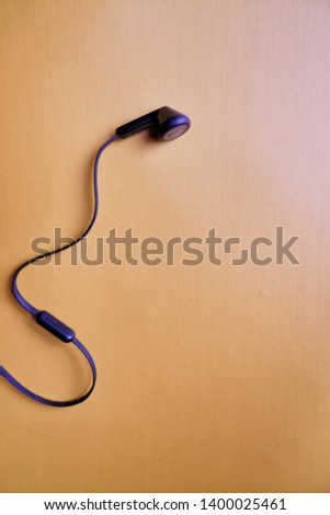 earphone in yellow background , view from the top