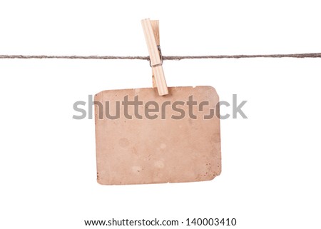 Blank instant photo hanging on the clothesline. Isolated on white background