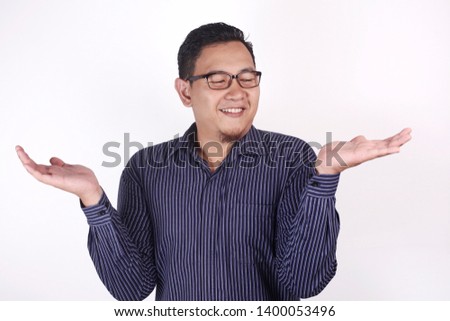 Portrait of Asian businessman shows empty hands, open palm with copy space, choose left or right concept