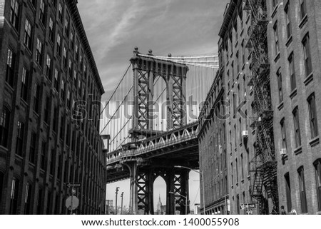 View of one of the towers of the Manhattan Bridge from the streets of the DUMBO district, Brooklyn, NYC black and white 