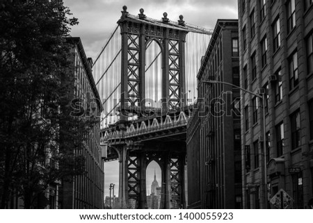 View of one of the towers of the Manhattan Bridge from the streets of the DUMBO district, Brooklyn, NYC black and white 