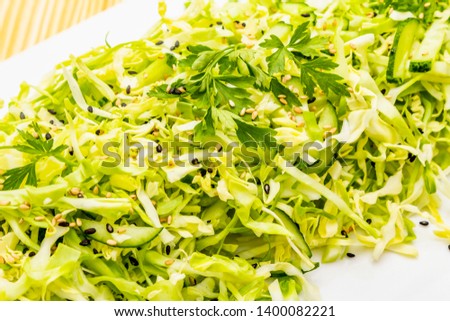 Fresh cabbage salad. Healthy vegan (vegetarian) food concept. Organic vegetables and sesame seeds, ceramic plate. On wooden background, close up, macro
