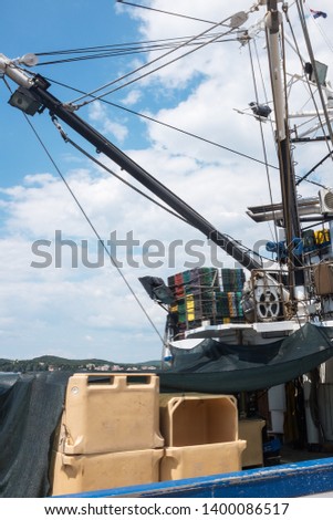 Fishing boat tied and anchored to the pier of Rovinj, Istria, Croatia, sunny summer day