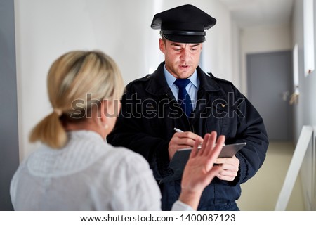 Policeman makes witness interview after burglary and talks with witnesses Royalty-Free Stock Photo #1400087123
