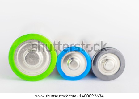 Alkaline batteries on the light background. The concept of recycling batteries, caring for the environment. Copy space. Macro photo. 