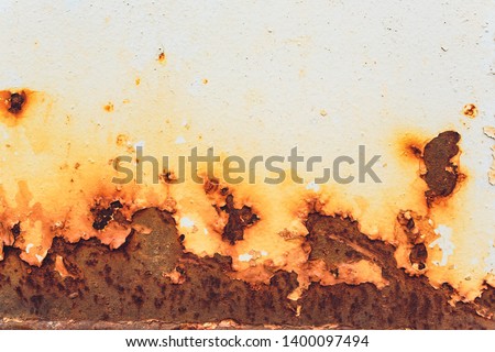 Rusted white painted metal wall. Rusty metal background with streaks of rust. Rust stains. The metal surface rusted spots.metal rust texture background. Royalty-Free Stock Photo #1400097494