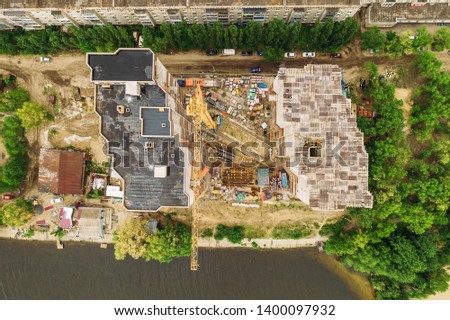Construction Site Aerial View, New Residential Building under Construction with Workers, Industrial Crane and Machinery Equipment, Drone Photo