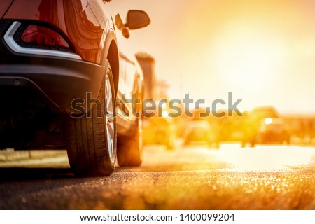 Sunset in the city, summer sunset on the highway cars. Close up from car side mirror. Royalty-Free Stock Photo #1400099204