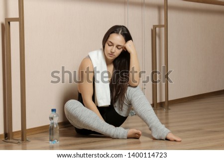 Beautiful girl dancer. tired girl dancer. girl ballerina or dancer is resting near the ballet barre in a dance studio after training.