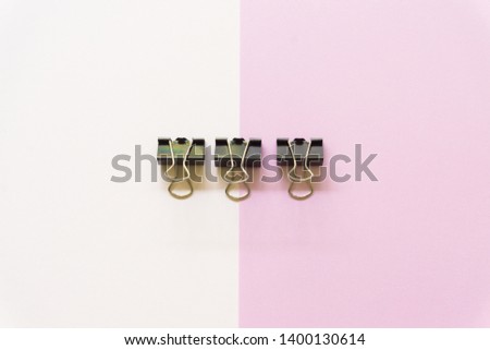black paper cilp on white background and pink background