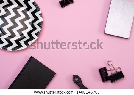 Beautiful gentle Flat lay on a pink background. Notepad, clothespins and plate on the table.
