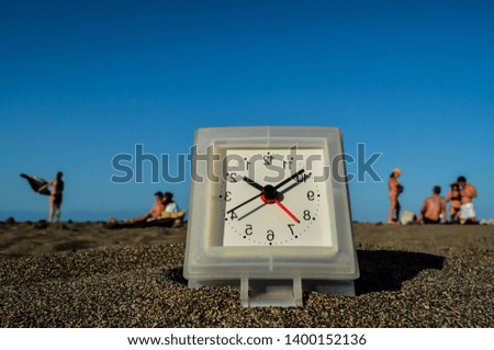 Photo Picture of a Clock on the Sand Beach
