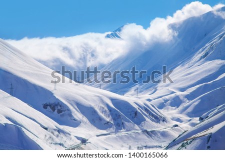 Georgian Mountains Panorama View with Clouds and Blue Sky
Sunny skiing snow hills Bright Nature Landscape