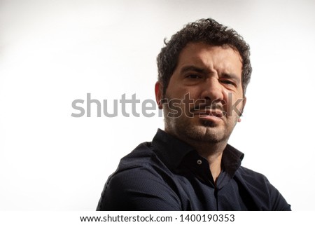Headshot of man frowning with perplexed or disgusted expression, isolated on white background.  Royalty-Free Stock Photo #1400190353