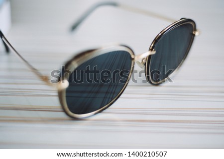 Black sunglasses on a wooden table background