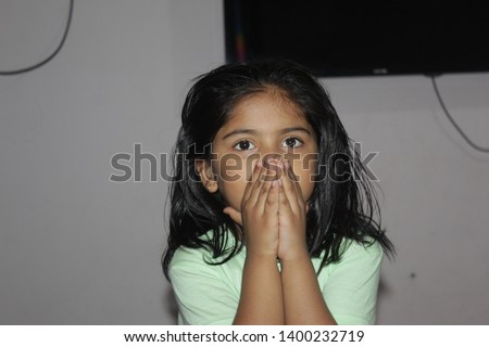 happy little girl in green t-shirt ,cute 5year little girl play at home
