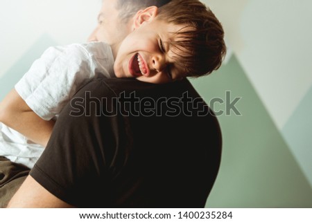 Father hugging and tickling son