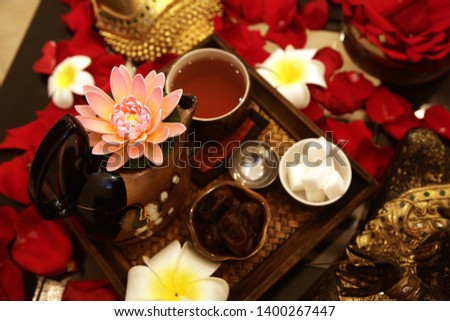 
tea ceremony with buddha and roses