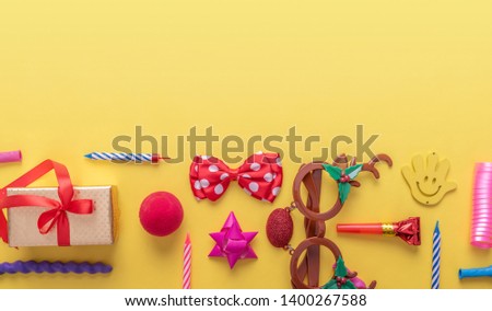 Items for carnival on a yellow background.