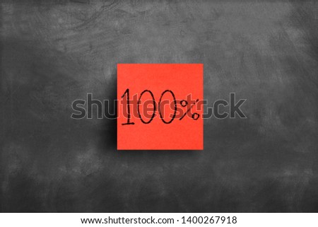 Sticky note on blackboard, 100 percent