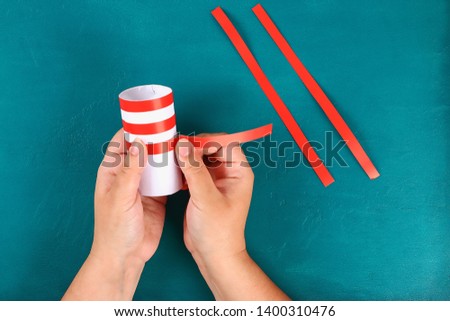 Diy 4th July petard toilet sleeve, paper, cardboard color American flag red blue white. Gift idea decor July 4, USA Independence Day. Step by step. Top view Process kid children craft. Workshop Royalty-Free Stock Photo #1400310476