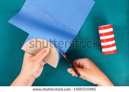 Diy 4th July petard toilet sleeve, paper, cardboard color American flag red blue white. Gift idea decor July 4, USA Independence Day. Step by step. Top view Process kid children craft. Workshop Royalty-Free Stock Photo #1400310485