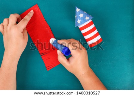 Diy 4th July petard toilet sleeve, paper, cardboard color American flag red blue white. Gift idea decor July 4, USA Independence Day. Step by step. Top view Process kid children craft. Workshop Royalty-Free Stock Photo #1400310527