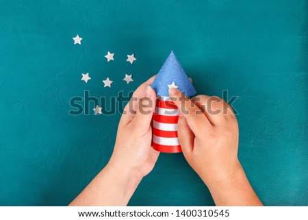 Diy 4th July petard toilet sleeve, paper, cardboard color American flag red blue white. Gift idea decor July 4, USA Independence Day. Step by step. Top view Process kid children craft. Workshop Royalty-Free Stock Photo #1400310545
