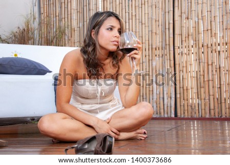 emotional latin girl with a glass of wine