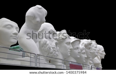 Plaster busts of some historical persons and ancient greek mythological characters isolated on black