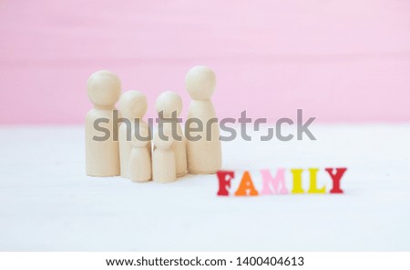 family and design concept - wooden family piece isolated on pink background