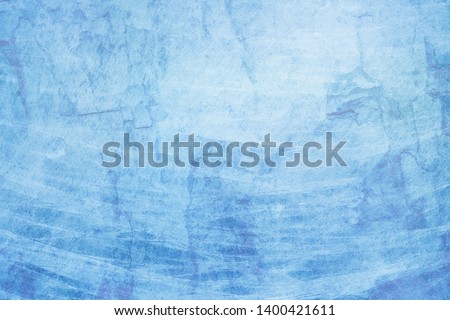 Blue background with old white grunge texture streaks cracks and lines in a distressed vintage design