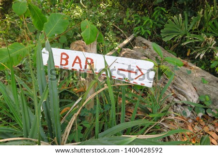 
Bar. Inscription on a wooden panel hidden in the grass.