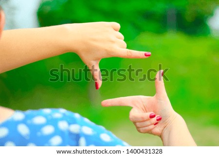 Close up of woman hands making frame gesture with sunrise.Female capturing the sunrise, Future planning, sunlight outdoor. 