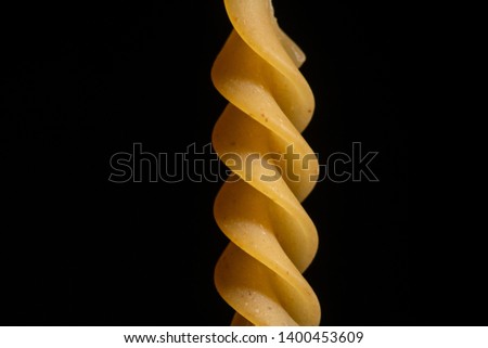 spiral pasta close up on black background