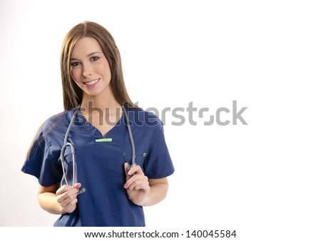 A nurse in scrubs pauses with stethoscope and looks at the camera