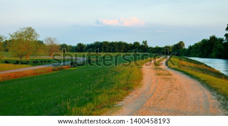 Levee between the Mississippi River and River Road near Baton Rouge, Louisiana, USA. Royalty-Free Stock Photo #1400458193