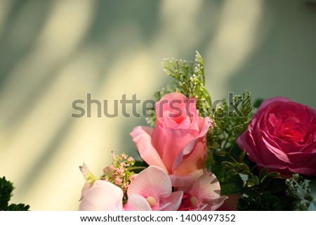 Vase of flowers on the side of the white cement wall  And have space for messages