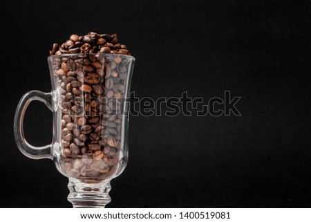 Black coffee in white cup and coffee beans on black background. Top view, space for text.