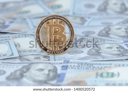 Bitcoin against the background of dollar bills. exchange bitcoin for dollars. fall of bitcoin.