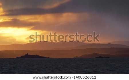 A beautiful landscape picture of a sunset over the Firth of Forth and Inchcolm Island near Edinburgh in Scotland, United Kingdom 