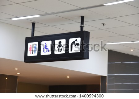 Public Toilet Sign board hanging with ceiling in the Airport