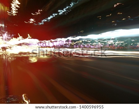 Light​ trails​ background.​ Different light trails of multicolored street lanterns and passing cars scattering in the dark.​ ​Abstract​ of​ light​ trail.
