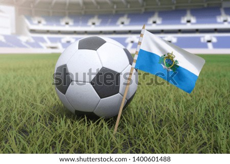 San Marino flag in stadium field with soccer football