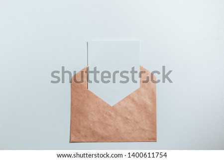 Kraft paper envelope with  letter on  white background. The envelope is on table