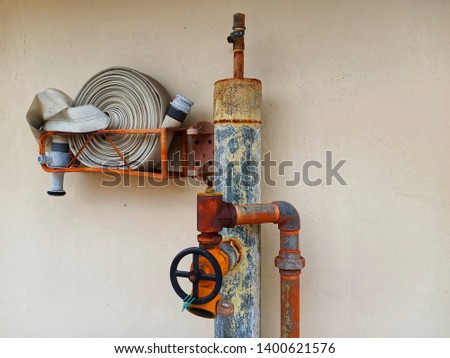 old and rusty building rooftop fire hydrant and fire host with copyspace stock photo -image