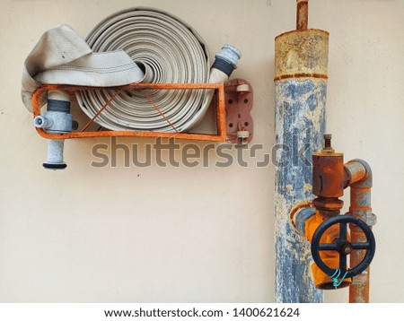 old and rusty building rooftop fire hydrant and fire host with copyspace stock photo -image