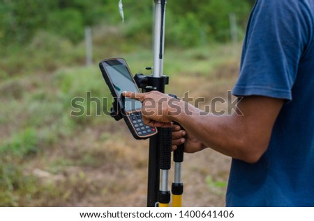 Land surveyor set up GPS GNSS instrument on the field Royalty-Free Stock Photo #1400641406