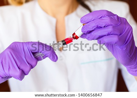 Woman hands holding syringe ampoule Royalty-Free Stock Photo #1400656847